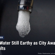 Fostoria News: Water running from a kitchen faucet, with headline: Fremont Water Still Earthy as City Awaits New MIB Results